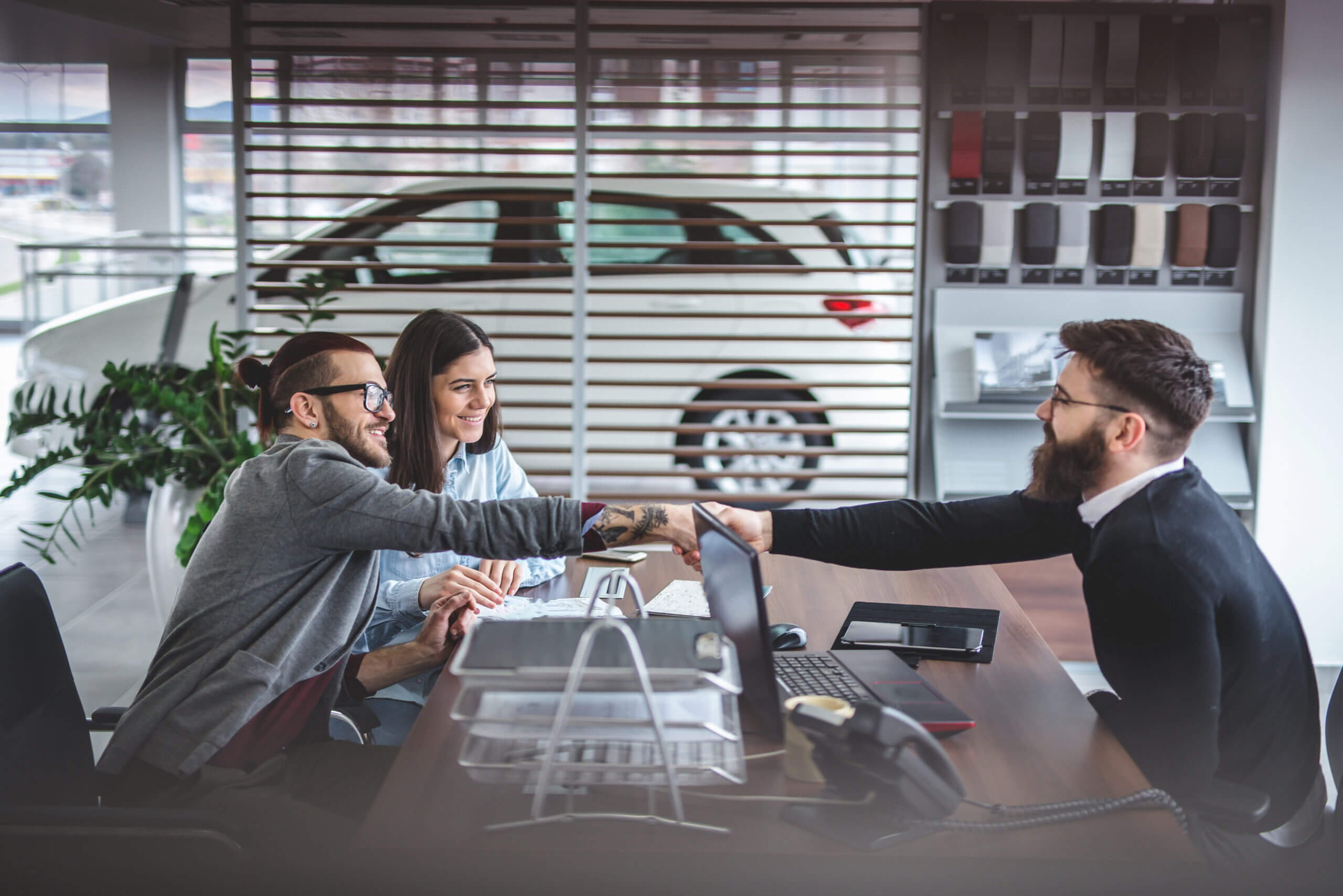 Customer handing keys to a dealership representative at a trade-in appraisal